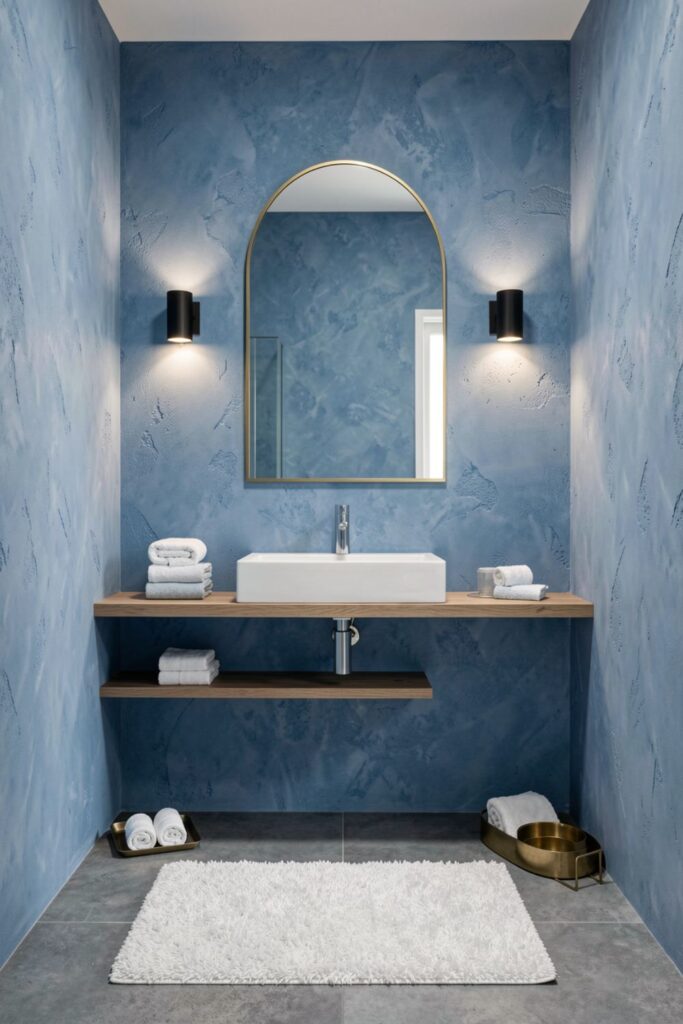 Azurite Accent Wall With Gold Arch Mirror And Sink Shelf
